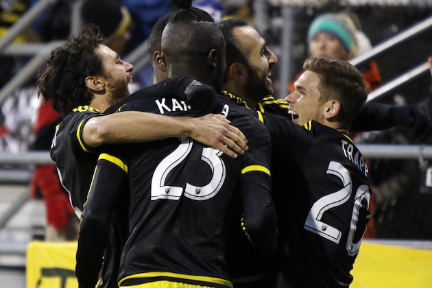 Columbus Crew team members forward Kei Kamara (23), midfielder Justin Meram (9) and midfielder Wil Trapp (20) celebrate Meram's goal with other members against the New York Red Bulls during the first half in the first leg of the MLS soccer Eastern Conference championship in Columbus, Ohio, Sunday, Nov. 22, 2015. (AP Photo/Paul Vernon)