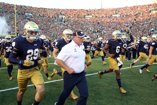 Sep 5, 2015; South Bend, IN, USA; Notre Dame Fighting Irish coach Brian Kelly leads his team onto the field before the game against the Texas Longhorns at Notre Dame Stadium. Mandatory Credit: Brian Spurlock-USA TODAY Sports