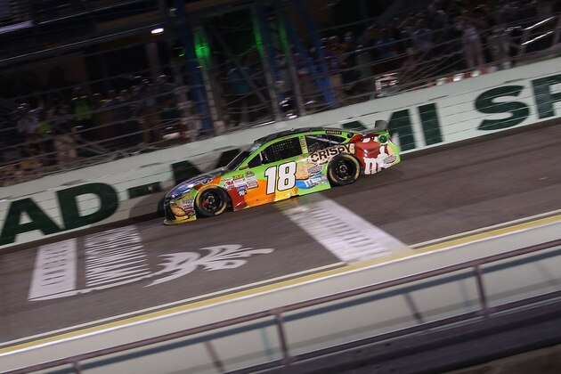HOMESTEAD, FL - NOVEMBER 22:  Kyle Busch, driver of the #18 M&M's Crispy Toyota, crosses the finish line to win the NASCAR Sprint Cup Series Ford EcoBoost 400 at Homestead-Miami Speedway on November 22, 2015 in Homestead, Florida.  (Photo by Chris Graythen/Getty Images)