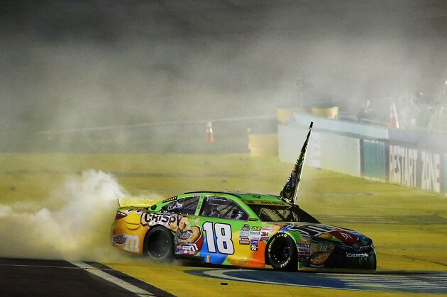 HOMESTEAD, FL - NOVEMBER 22:  Kyle Busch, driver of the #18 M&M's Crispy Toyota, celebrates winning the series championship and the race with a burnout after the NASCAR Sprint Cup Series Ford EcoBoost 400 at Homestead-Miami Speedway on November 22, 2015 in Homestead, Florida.  (Photo by Mike Ehrmann/Getty Images)