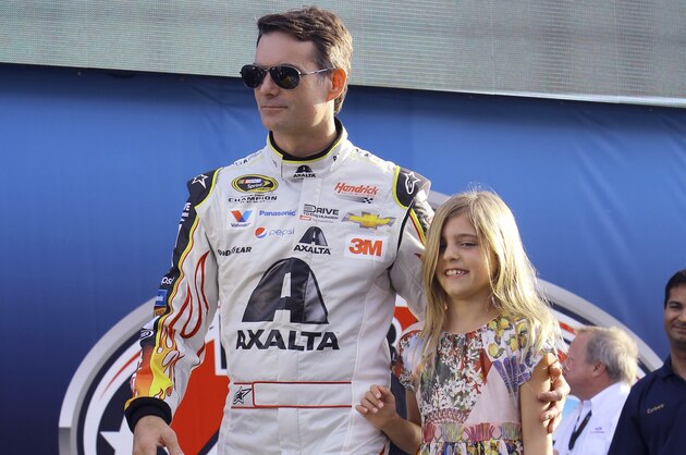 Jeff Gordon walks with his daughter Ella during the driver introductions at the NASCAR Sprint Cup Series auto race, Sunday, Nov. 22, 2015, at Homestead-Miami Speedway in Homestead, Fla. (AP Photo/David  Graham)