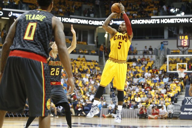 Cleveland Cavaliers guard J.R. Smith (5) shoots over Atlanta Hawks guard Kyle Korver (26) in the first half of an NBA preseason basketball game, Wednesday, Oct. 7, 2015, in Cincinnati. The Hawks won 98-96. (AP Photo/John Minchillo)