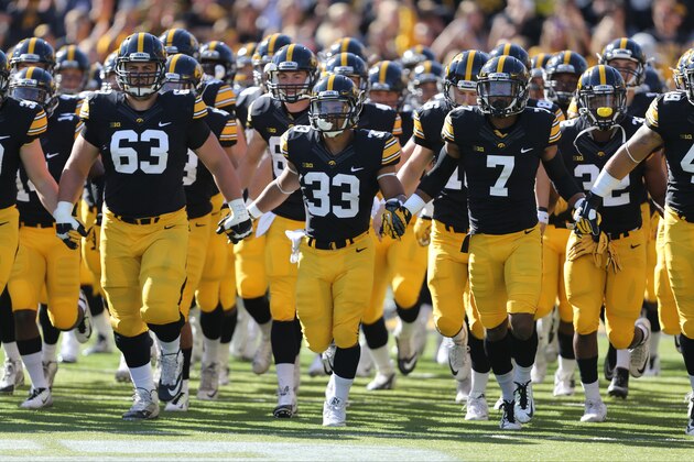 The Iowa Hawkeyes take the field before the start of an NCAA college football game against Illinois, Saturday, Oct. 10, 2015, in Iowa City, Iowa. (AP Photo/Justin Hayworth)