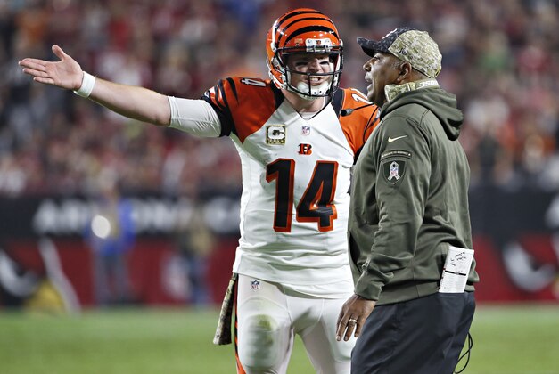 Cincinnati Bengals quarterback Andy Dalton (14) and Cincinnati Bengals head coach Marvin Lewis discuss a call during the first half of an NFL  football game against the Arizona Cardinals, Sunday, Nov. 22, 2015, in Glendale, Ariz. (AP Photo/Ross D. Franklin)