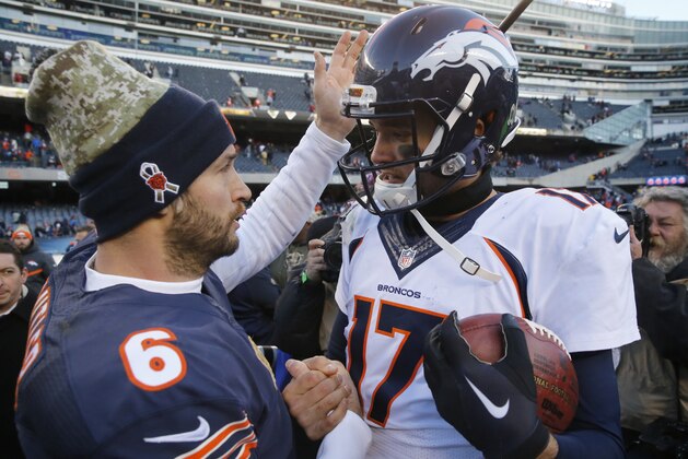 Chicago Bears quarterback Jay Cutler (6) talks to Denver Broncos quarterback Brock Osweiler (17) after an NFL football game, Sunday, Nov. 22, 2015, in Chicago. The Broncos won 17-15. (AP Photo/Charles Rex Arbogast)