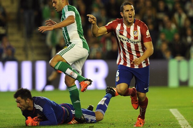 Atletico Madrid's midfielder Koke (R) celebrates after scoring a goal during the Spanish league football match Real Betis Balompie vs Club Atletico de Madrid at the Benito Villamarin stadium in Sevilla on November 22, 2015.  AFP PHOTO / CRISTINA QUICLER        (Photo credit should read CRISTINA QUICLER/AFP/Getty Images)