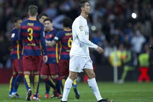 MADRID, SPAIN - NOVEMBER 21:  Cristiano Ronaldo of Real Madrid CF leaves the pithc as FC Barcelona players celebrate their victory after the La Liga match between Real Madrid CF and FC Barcelona at Estadio Santiago Bernabeu on November 21, 2015 in Madrid, Spain.  (Photo by Gonzalo Arroyo Moreno/Getty Images)