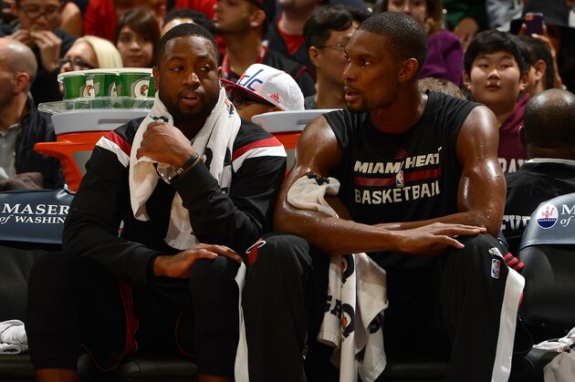 WASHINGTON, DC - DECEMBER 01:  Dwyane Wade #3 and Chris Bosh #1 of the Miami Heat sit on the bench during the game against the Washington Wizards at the Verizon Center on December 1, 2014 in Washington, DC.  (Photo by G Fiume/Getty Images)