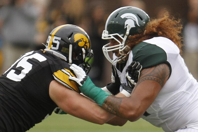 IOWA CITY, IOWA - OCTOBER 5:  Offensive lineman Fou Fonoti #51 of the Michigan State Spartans battles during the second quarter with defensive lineman Drew Ott #95 of the Iowa Hawkeyes on October 5, 2013 at Kinnick Stadium in Iowa City, Iowa. Michigan State won 26-14. (Photo by Matthew Holst/Getty Images)