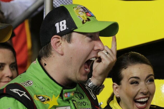 Kyle Busch celebrates after winning the NASCAR Sprint Cup Series auto race and the season title Sunday, Nov. 22, 2015, at Homestead-Miami Speedway in Homestead, Fla. (AP Photo/Terry Renna)