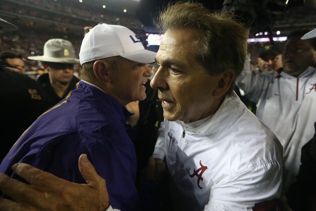 LSU head coach Les Miles, left, and Alabama head coach Nick Saban speak at midfield after the second half of an NCAA college football game Saturday, Nov. 7, 2015, in Tuscaloosa , Ala. Alabama won 30-16. (AP Photo/John Bazemore)