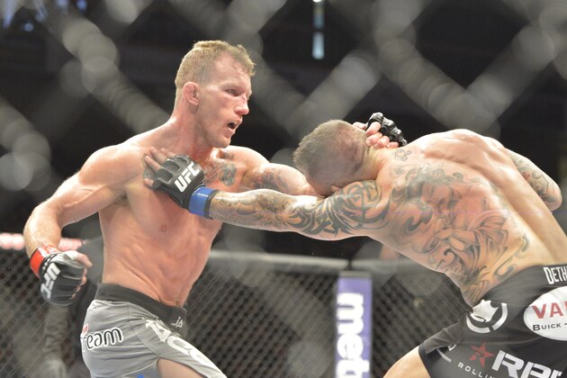 Aug 16, 2014; Bangor, ME, USA; Gray Maynard (red gloves) fights Ross Pearson (blue gloves) during lightweight bout at Cross Insurance Center. Mandatory Credit: Gregory J. Fisher-USA TODAY Sports
