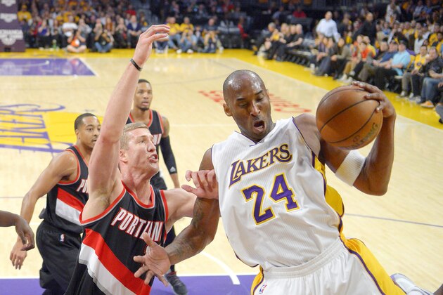 Los Angeles Lakers forward Kobe Bryant, right, grabs a rebound away from Portland Trail Blazers center Mason Plumlee during the first half of an NBA basketball game, Sunday, Nov. 22, 2015, in Los Angeles. (AP Photo/Mark J. Terrill)