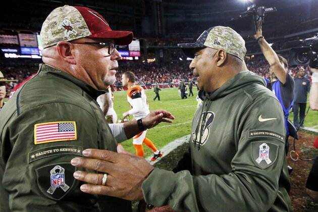 Arizona Cardinals head coach Bruce Arians, left, greets Cincinnati Bengals head coach Marvin Lewis, right, on the field after an NFL football game Sunday, Nov. 22, 2015, in Glendale, Ariz.  The Cardinals defeated the Bengals 34-31. (AP Photo/Ross D. Franklin)