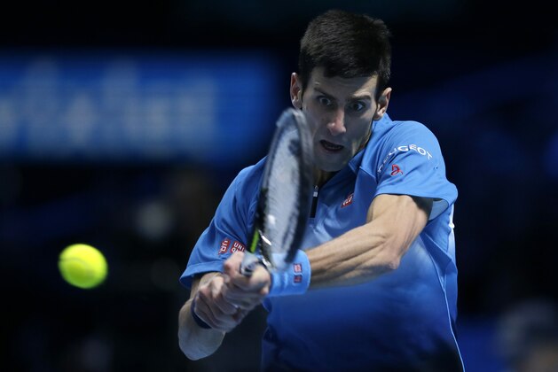 Novak Djokovic of Serbia plays a return to Roger Federer of Switzerland during their ATP World Tour Finals final tennis match at the O2 Arena in London, Sunday Nov. 22, 2015. (AP Photo/Tim Ireland)