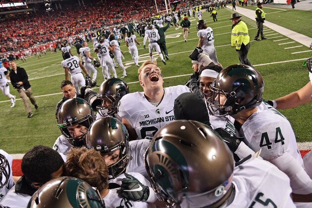 COLUMBUS, OH - NOVEMBER 21:  The Michigan State Spartans crowd around kicker Michael Geiger #4 of the Michigan State Spartans to celebrate after Geiger's 41-yard field goal defeated the Ohio State Buckeyes at Ohio Stadium on November 21, 2015 in Columbus, Ohio. Michigan State defeated Ohio State 17-14.  (Photo by Jamie Sabau/Getty Images)