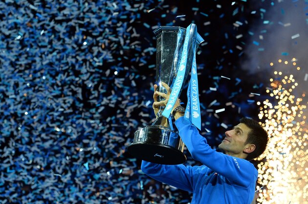 Serbia's Novak Djokovic holds up the ATP trophy after winning the men's singles final match against Switzerland's Roger Federer on day eight of the ATP World Tour Finals tennis tournament in London on November 22, 2015. 
AFP PHOTO / GLYN KIRK        (Photo credit should read GLYN KIRK/AFP/Getty Images)