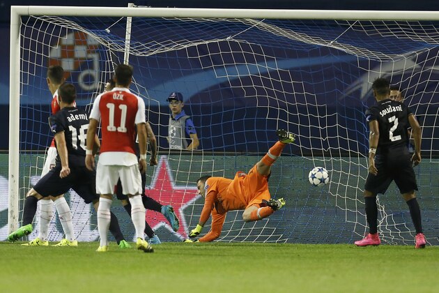 Arsenal goalkeeper David Ospina, centre, concedes the 2nd goal scored by Zagreb's Junior Fernandes, unseen, during a Champions League Group F soccer match between Dinamo Zagreb and Arsenal at the Maksimir Stadium in Zagreb, Croatia, Wednesday Sept. 16, 2015. (AP Photo/Darko Bandic)