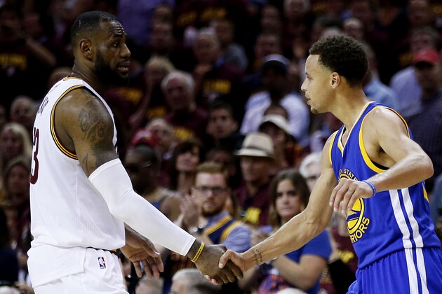 CLEVELAND, OH - JUNE 16:  LeBron James #23 of the Cleveland Cavaliers shakes hands with Stephen Curry #30 of the Golden State Warriors after the Warriors defeated the Cavs 105 to 97 to win Game Six of the 2015 NBA Finals at Quicken Loans Arena on June 16, 2015 in Cleveland, Ohio. NOTE TO USER: User expressly acknowledges and agrees that, by downloading and or using this photograph, user is consenting to the terms and conditions of Getty Images License Agreement.  (Photo by Ezra Shaw/Getty Images)