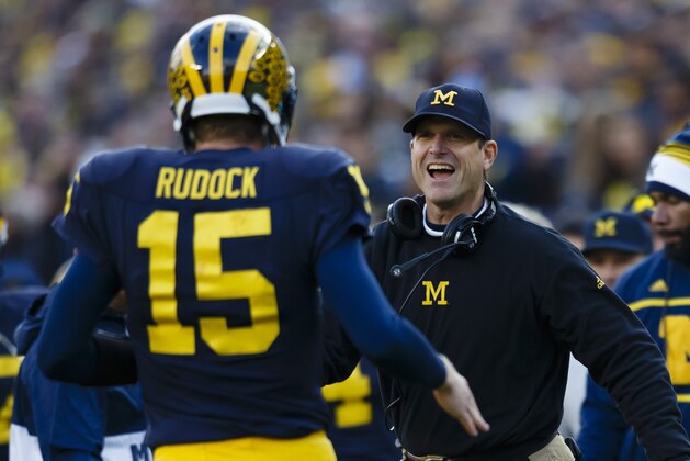 Nov 7, 2015; Ann Arbor, MI, USA; Michigan Wolverines quarterback Jake Rudock (15) receives congratulations from head coach Jim Harbaugh after passing for a touchdown in the first quarter against the Rutgers Scarlet Knights at Michigan Stadium. Mandatory Credit: Rick Osentoski-USA TODAY Sports