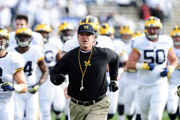 STATE COLLEGE, PA - NOVEMBER 21:  Jim Harbaugh head coach of the Michigan Wolverines run onto the field prior to the game against the Penn State Nittany Lions at Beaver Stadium on November 21, 2015 in State College, Pennsylvania.  (Photo by Evan Habeeb/Getty Images)