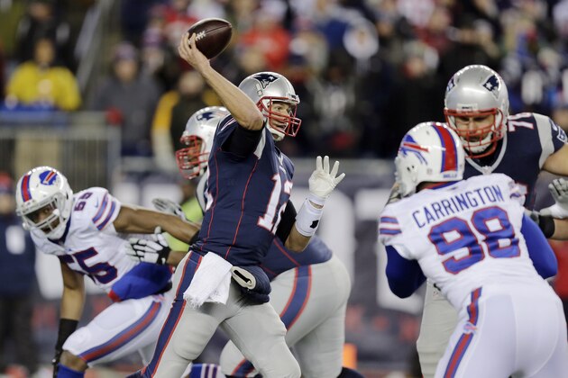 New England Patriots quarterback Tom Brady (12) passes against pressure from Buffalo Bills defensive end Alex Carrington (98) in the first half of an NFL football game Monday, Nov. 23, 2015, in Foxborough, Mass. (AP Photo/Charles Krupa)