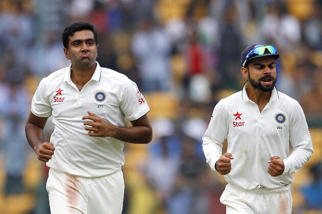 India's Ravichandran Ashwin, left, and captain Virat Kohli celebrate the dismissal of South Africa's Morne Morkel during the first day of their second cricket test match in Bangalore, India, Saturday, Nov. 14, 2015. (AP Photo/Aijaz Rahi)