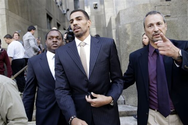 Thabo Sefolosha, center, leaves criminal court in New York, Friday, Oct. 9, 2015. The Atlanta Hawks' player was acquitted Friday in a case stemming from a police fracas outside a trendy New York City nightclub. (AP Photo/Seth Wenig)