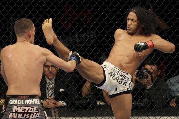 Ben Henderson, right, kicks Nate Diaz during a lightweight championship mixed martial arts bout at a UFC on Fox event in Seattle, Saturday, Dec. 8, 2012. Henderson won by unanimous decision to retain his championship. (AP Photo/Jeff Chiu)
