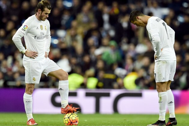 Real Madrid's Welsh forward Gareth Bale (L) and Real Madrid's Portuguese forward Cristiano Ronaldo stand during the Spanish league 'Clasico' football match Real Madrid CF vs FC Barcelona at the Santiago Bernabeu stadium in Madrid on November 21, 2015. AFP PHOTO/ JAVIER SORIANO        (Photo credit should read JAVIER SORIANO/AFP/Getty Images)