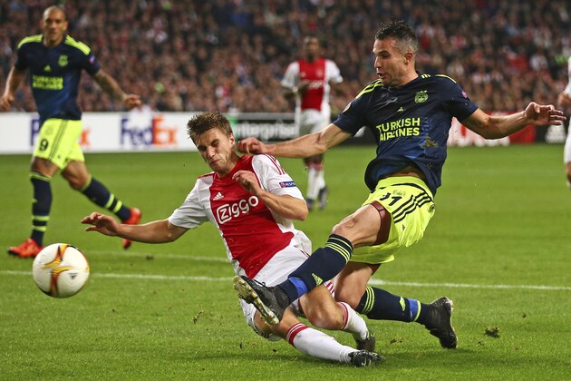 Ajax's Joel Veltman blocks a shot by Fenerbahce’s Robin van Persie, right, during the Europa League group A soccer match between Ajax and Fenerbahce at the ArenA stadium in Amsterdam, Netherlands, Thursday, Nov. 5, 2015. (AP Photo/Peter Dejong) Ajax's Joel Veltman blocks a shot by Fenerbahce’s Robin van Persie, right, during the Europa League group A soccer match between Ajax and Fenerbahce at the ArenA stadium in Amsterdam, Netherlands, Thursday, Nov. 5, 2015. (AP Photo/Peter Dejong)
