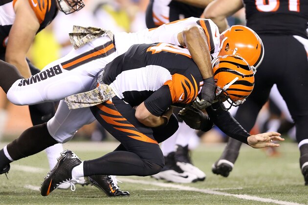 CINCINNATI, OH - NOVEMBER 5:  Andy Dalton #14 of the Cincinnati Bengals is sacked by Desmond Bryant #92 of the Cleveland Browns during the second quarter at Paul Brown Stadium on November 5, 2015 in Cincinnati, Ohio. (Photo by Andy Lyons/Getty Images)