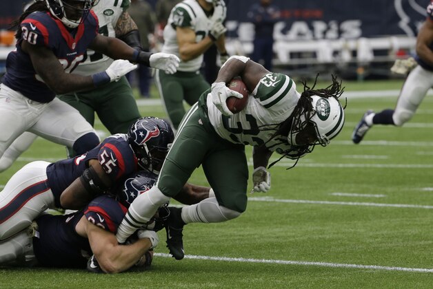 New York Jets running back Chris Ivory (33) is tackled by the Houston Texans during the first half of an NFL football game, Sunday, Nov. 22, 2015, in Houston. (AP Photo/David J. Phillip)