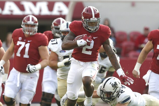 Alabama running back Derrick Henry (2) carries the ball for a first down as he is tripped up by Charleston Southern linebacker Zack Johnson (22) during the first half of an NCAA football game, Saturday, Nov. 21, 2015, in Tuscaloosa, Ala. (AP Photo/Butch Dill)