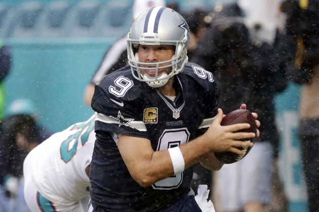Dallas Cowboys quarterback Tony Romo (9) prepares to throw with his left hand as he scrambles in the end zone during the first half of an NFL football game against the Miami Dolphins, Sunday, Nov. 22, 2015, in Miami Gardens, Fla. The Cowboys defeated the Dolphins 24-14.  (AP Photo/Wilfredo Lee)