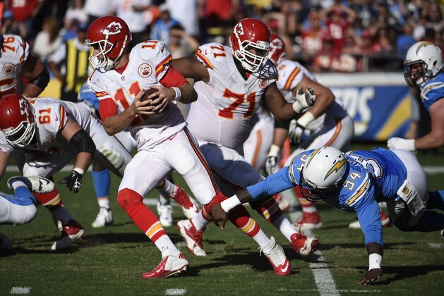Kansas City Chiefs quarterback Alex Smith gets away from San Diego Chargers outside linebacker Melvin Ingram during the first half of an NFL football game Sunday, Nov. 22, 2015, in San Diego. (AP Photo/Denis Poroy)