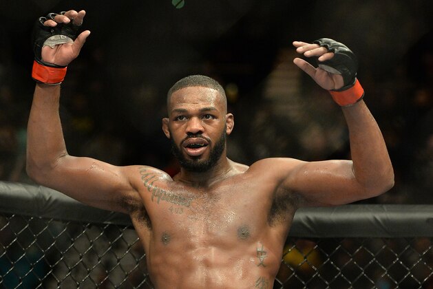 Jan 3, 2015; Las Vegas, NV, USA; Jon Jones (red gloves) celebrates after defeating Daniel Cormier (not pictured) in their light heavyweight title fight at UFC 182 at the MGM Grand Garden Arena. Jones won. Mandatory Credit: Jayne Kamin-Oncea-USA TODAY Sports