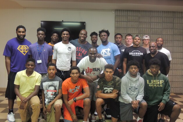 A handful of Tampa area high school football players recently teamed with WWE star Titus O'Neil to serve Thanksgiving dinner to the area's homeless community.
