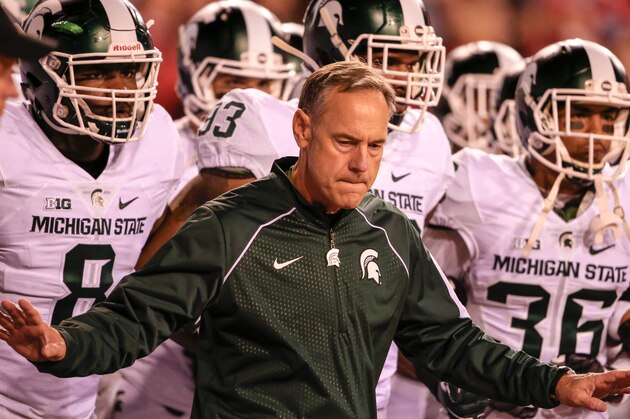 Michigan State head coach Mark Dantonio holds back his players from taking the field before an NCAA college football game against Nebraska in Lincoln, Neb., Saturday, Nov. 7, 2015. Nebraska won 39-38. (AP Photo/Nati Harnik)