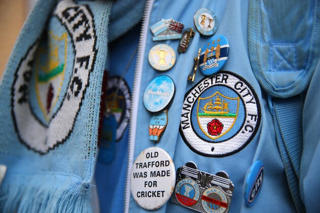 LONDON, ENGLAND - OCTOBER 27:  A Man City supporter shows off his pin badges ahead of the Barclays Premier League match between Chelsea and Manchester City at Stamford Bridge on October 27, 2013 in London, England.  (Photo by Clive Rose/Getty Images)