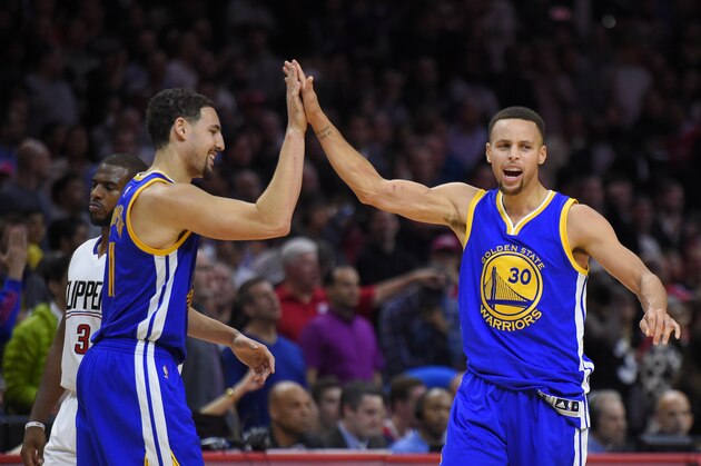 Golden State Warriors guard Stephen Curry, right, celebrates with guard Klay Thompson, center as Los Angeles Clippers guard Chris Paul walks by during the second half of an NBA basketball game, Thursday, Nov. 19, 2015, in Los Angeles.  The Warriors won 124-117. (AP Photo/Mark J. Terrill)