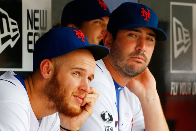 NEW YORK, NY - AUGUST 31:  Zack Wheeler #45 (L) and Matt Harvey #33 of the New York Mets look on against the Philadelphia Phillies at Citi Field on August 31, 2014 in the Flushing neighborhood of the Queens borough of New York City. The Mets defeated the Phillies 6-5.  (Photo by Jim McIsaac/Getty Images)