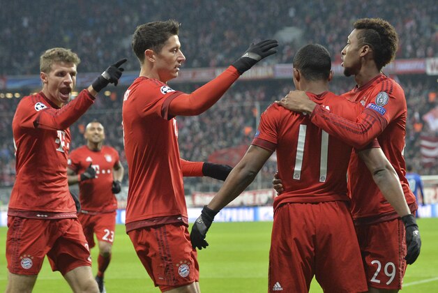 Bayern's Douglas Costa, second from right, celebrates with his teammates after scoring during the Champions League group F soccer match between FC Bayern Munich and Olympiakos in Munich, Germany, Tuesday, Nov. 24, 2015. (AP Photo/Kerstin Joensson)