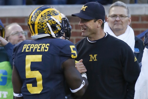 Michigan's Jabrill Peppers (5) celebrates with head coach Jim Harbaugh after scoring a touchdown against Rutgers during the first half of an NCAA college football game Saturday, Nov. 7, 2015, in Ann Arbor, Mich. (AP Photo/Duane Burleson)
