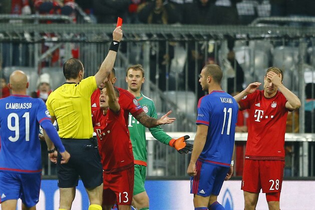 Bayern's Holger Badstuber, right, receives a red card from the referee during the Champions League Group F soccer match between FC Bayern Munich and Olympiakos Piraeus in Munich, Germany, Tuesday Nov. 24, 2015. (AP Photo/Matthias Schrader)