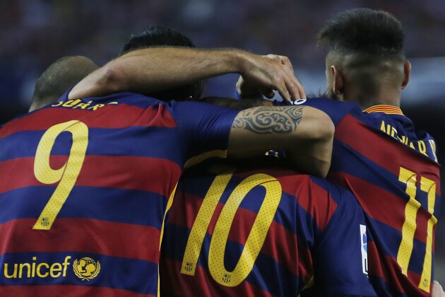 Barcelona’s Lionel Messi, centre, celebrates with Luis Suarez, left, and Neymar after scoring during a Spanish La Liga soccer match between Atletico Madrid and Barcelona at the Vicente Calderon stadium in Madrid, Spain, Saturday Sept. 12, 2015. (AP Photo/Paul White)