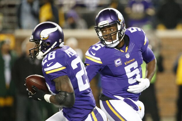 Minnesota Vikings quarterback Teddy Bridgewater (5) hands off to running back Adrian Peterson (28) during the second half of an NFL football game against the Green Bay Packers in Minneapolis, Sunday, Nov. 22, 2015. (AP Photo/Ann Heisenfelt)