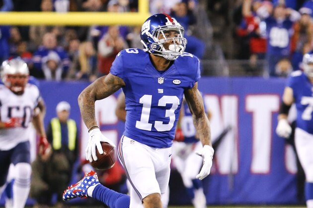 New York Giants wide receiver Odell Beckham (13) runs away from New England Patriots' Malcom Brown (90) and Rob Ninkovich (50) for a touchdown during the first half of an NFL football game, Sunday Nov. 15, 2015, in East Rutherford, N.J. (AP Photo/Julio Cortez)