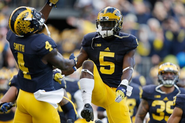 ANN ARBOR, MI - NOVEMBER 07:  Jabrill Peppers #5 and De'Veon Smith #4 of the Michigan Wolverines take the field prior to playing the Rutgers Scarlet Knights on November 7, 2015 at Michigan Stadium in Ann Arbor, Michigan. Michigan won the game 49-16.  (Photo by Gregory Shamus/Getty Images)