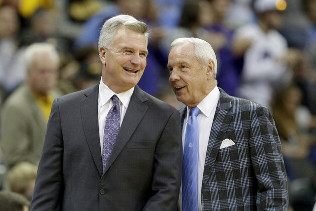 Kansas State coach Bruce Weber, left and North Carolina coach Roy Williams talk before an NCAA college basketball game Tuesday, Nov. 24, 2015, in Kansas City, Mo. (AP Photo/Charlie Riedel)